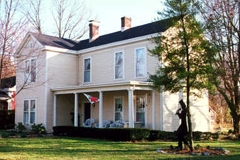 a tree in front of a house